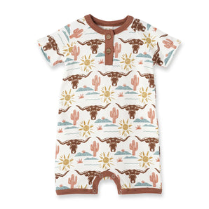 Tesa Babes Bamboo Romper, Happy Trails: white with brown longhorns, yellow suns, pink cacti; brown trim & buttons. Perfect for a cowboy!.