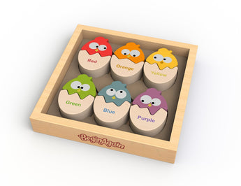 Color N Eggs wooden tray features 6 colorful chickens: red, orange, yellow, green, blue, purple. Engages fine motor skills by Begin Again.