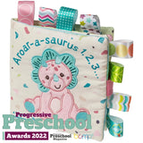 Soft Book, Aroarasaurus by Mary Meyer is a dinosaur-themed baby book with colorful Taggies ribbons, perfect for bedtime stories.
