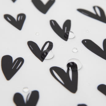 Close-up of water droplets on a Bumkins SuperBib® and Sleeved Bib 3-Piece Set: Always Hungry, XOXO, Hearts.