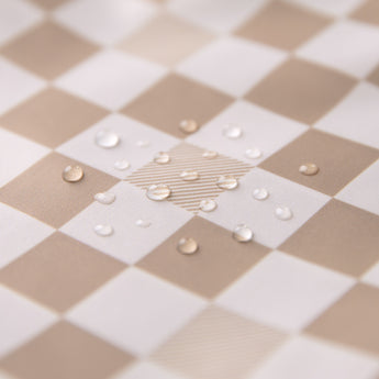 Close-up of water droplets on a Roamio by Bumkins Clear Travel Bag 3 Pack: Sand Check.