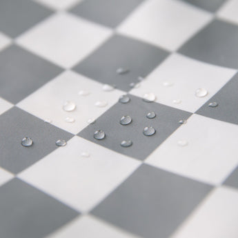 Close-up of water droplets on Bumkins Junior Bib: Charcoal Check.