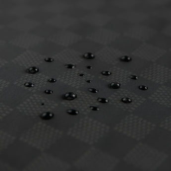Close-up of water droplets on Roamio by Bumkins Wet Bag: Rich Black.