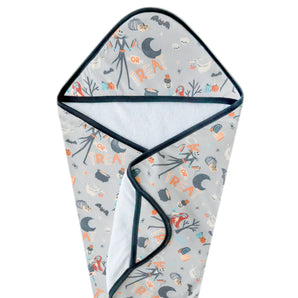Copper Pearls Hooded Towel features a Halloween theme with ghosts, pumpkins, bats, and Trick or Treat on gray.