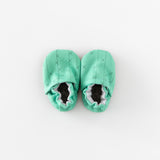 Cabooties Cactus Spines: Mint green baby booties with crisscross stitching and elastic closure, displayed on a white background.