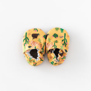Cabooties Arizona Animals: Yellow baby shoes with desert illustrations, rubber soles, and elastic ankle closures by Cabooties.