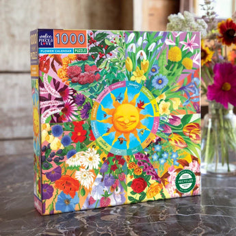 The Eeboo 1000 Piece Puzzle, Flower Calendar features a smiling sun and colorful flowers, perfect for any table setting.