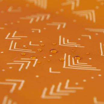 Close-up of water droplets on Bumkins Splat Mat: Grounded.