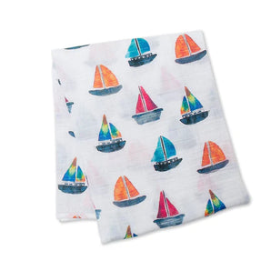 Lulujo Inc.s Cotton Swaddle, Sailboats: White fabric with red, blue, and green sailboat patterns ideal for swaddles or baby blankets.