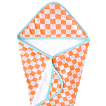 The Hooded Towel, Mickey Mouse Check by copp is an orange and white checkered towel with blue Mickey Mouse silhouettes and trim.
