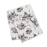 The extra-large Bamboo Swaddle by Lulujo Inc. features a neat black floral design, perfect for versatile use.