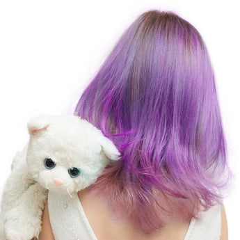 With vibrant purple hair from Piggy Paints Kid Safe Hair Color & Conditioner and a plush white cat, they exude kid-friendly charm.