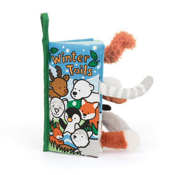 Explore the whimsical Winter Tails by Jellycat, a touch-and-feel cloth book with playful winter animals and plush tails.