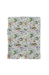 A LouLou Lollipop muslin swaddle with caterpillars, letters, and fruits on white, inspired by The Very Hungry Caterpillar.
