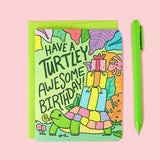 Turtle Soups Birthday Card, Turtley Awesome features a turtle with gifts on recycled paper. Includes pen & envelope.