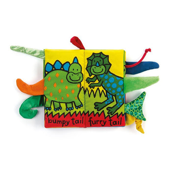 The Jellycat Dino Tails Cloth Book for kids has cartoon dinos with bumpy and furry textured tails.