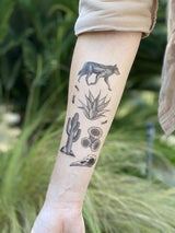 NatureTats Desert Wild tattoo captures the allure of the American Southwest with a wolf, agave, cactus, and bird skull.