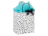 Zoolikins Gift Wrapping: White bag with black spots, turquoise tissue paper, and black bow—ideal for greeting card gifts.