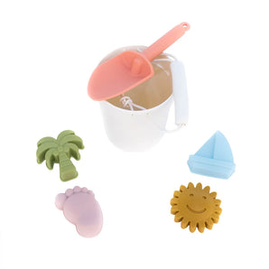 Emerson and Friends Beach Bucket Toy Play Set: silicone bucket with pink shovel and pastel sea-themed molds like palm tree, foot, sun, sailboat.