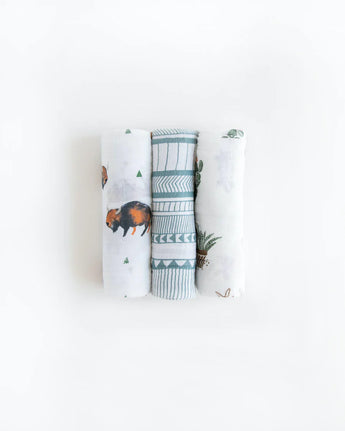 Little Unicorns Cotton Swaddle Set includes three blankets with bison, geometric patterns, and turtle prints on a white background.