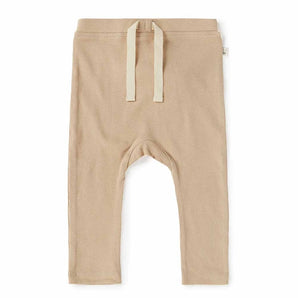 Snuggle Hunny Organic Pants, Pebble: Ribbed, beige, organic cotton toddler leggings with drawstring waist laid on white.