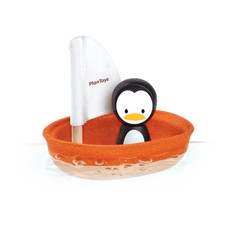 PlanToys Sailing Boat, Penguin features a penguin in a small orange vessel with a white PlanToys sail made from sustainable PlanWood.