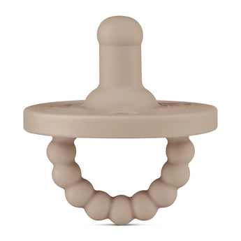 A Ryan & Rose pacifier and teether, Dune, by Round. Beige with a beaded ring handle, made of medical-grade silicone.
