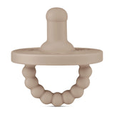 The Ryan & Rose Cutie PAT, a medical-grade silicone round pacifier and teether in Dune, features a beaded ring handle.