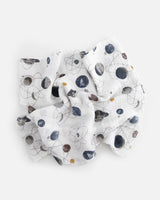 The Little Unicorn Cotton Swaddle, Planetary features a lightweight space-themed pattern with planets, rockets, and stars.