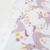The Lulujo Inc. Security Blanket features breathable muslin with whimsical purple unicorns and colorful flowers, perfect for comfort.