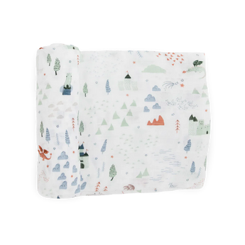 Little Unicorns Bamboo Swaddle, Dragon Days, features a soft rayon muslin with mountains, trees, castles, clouds & a red dragon.