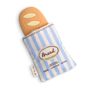 Baguette Teensy Crinkle: tan silicone bread toy and blue & cream striped fabric pouch; text "Bread Traditional French Bakery Paris London Rome."