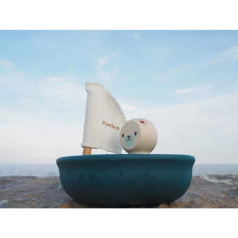 Sailing Boat, Polar Bear by PlanToys: A toy sailboat featuring a smiling bear and fabric sail. Enjoy sustainable play!.