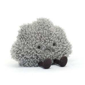 The Jellycat Amuseable Storm Cloud: a plush gray cloud with a sad face and brown legs, adorably seated on white.