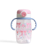 Itzy Sips, Ribbons & Roses: clear cup with pink bow & flower design, purple silicone handles, and white & pink lid.