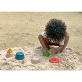 Child enjoyed a sunny day with PlanToys Creative Sand Play, using molds to boost fine motor skills and imagination.