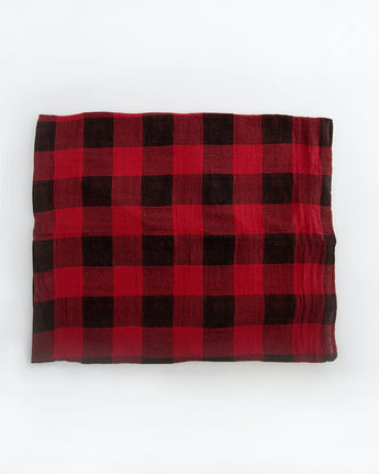 Little Unicorn Cotton Swaddle in Red Plaid laid flat on a white background.