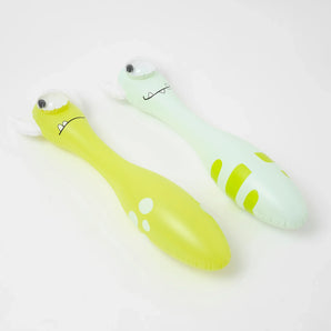 Two Sunnylife inflatable toys: Monty the Monster (lime green with spots) and a striped light green one, both on white.