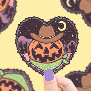 Turtle Soups Cowboy Pumpkin vinyl sticker features a jack-o-lantern in a heart-shaped desert night scene with cowboy hat and bandana.