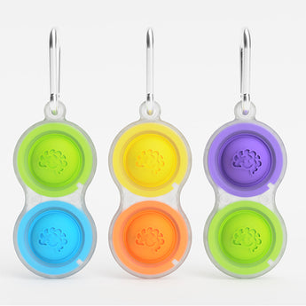 Pet bowls with colorful tactile designs in blue/green, yellow/orange, and purple/green come with carabiners. Brand: Fat Brain Toy Co.