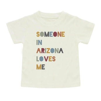 Emerson and Friends Luxury Tee for kids features Someone in Arizona colorful text on a white, unique luxury cotton shirt.
