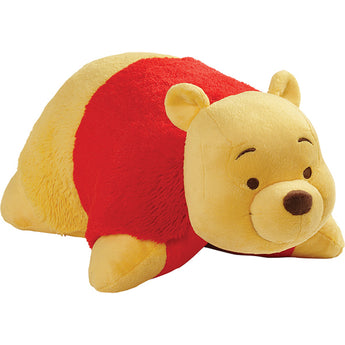 Winnie the Pooh Pillow Pet: a yellow bear with a red shirt lying on its belly, by Pillow Pets.