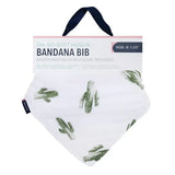 Bebe Au Laits Bandana Bib, Saguaro: white muslin, bamboo-cotton blend with green cactus print, label and dark blue hanging strap.