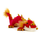 Meet Jellycats Festival Dragon: a plush red-orange toy with yellow spikes, fluffy tail, and expressive face lying down.