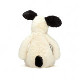 Bashful Black & Cream Puppy by Jellycat, featuring white fur and black ears, shown from the back.