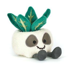 Jellycat Amuseables Skull Planter: a plush white pot with a smile, leafy green plant top, and gray arms and legs.