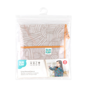 Bumkins Long-Sleeved Art Smock: Wander is shown folded in plastic packaging bag with a hanger and cardboard insert.