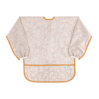Bumkins Long-Sleeved Art Smock: Wander—beige waterproof fabric with white abstract design, orange trim, front pocket, and adjustable tie closure.
