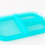 Close-up of the lid of Bumkins Silicone Bento Box 3 Section: Blue Jelly on a white background.