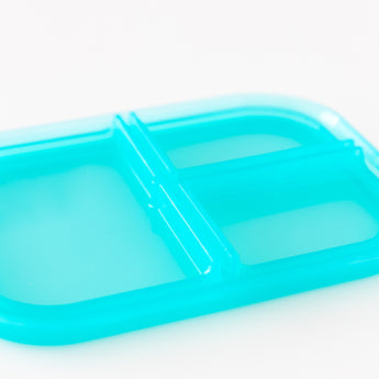 Close-up of the lid of Bumkins Silicone Bento Box 3 Section: Blue Jelly on a white background.